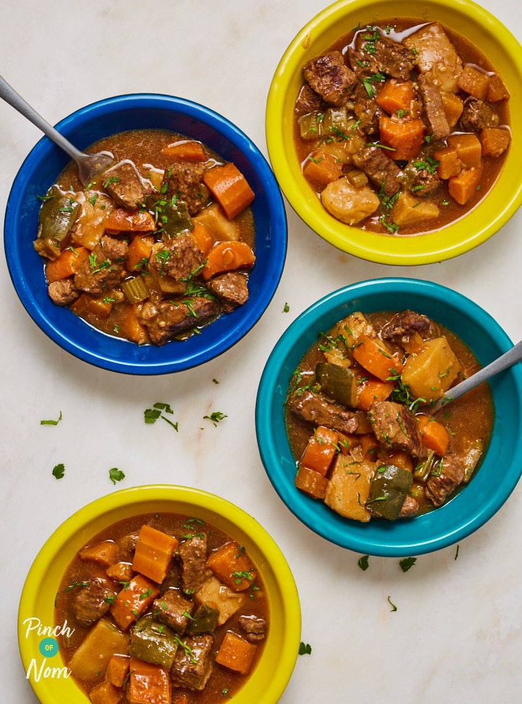 A table is set with four colourful bowls of Pinch of Nom's slimming-friendly Beef Stew.