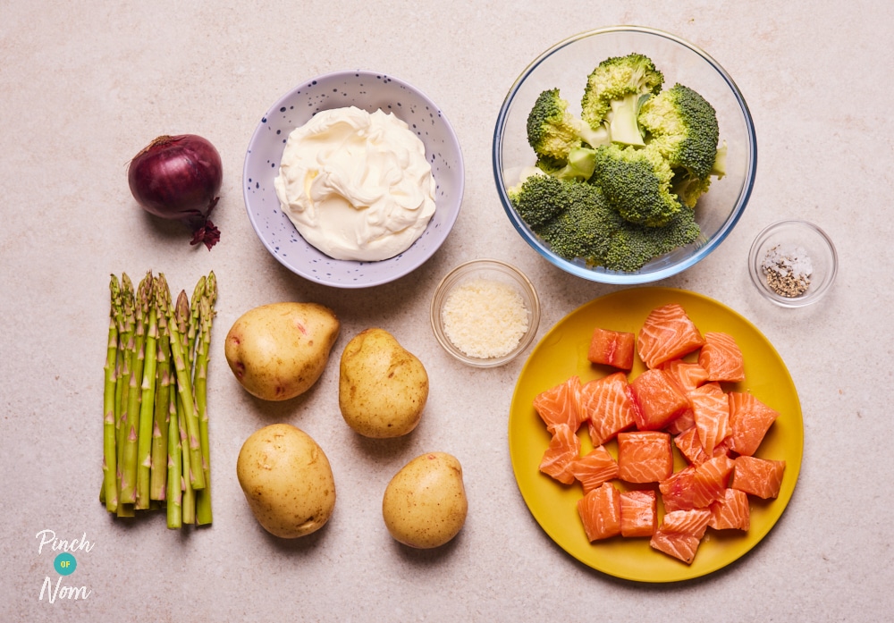 The raw ingredients for Pinch of Nom's slimming-friendly Salmon, Broccoli and Potato bake are laid out on a kitchen counter, ready to begin cooking.