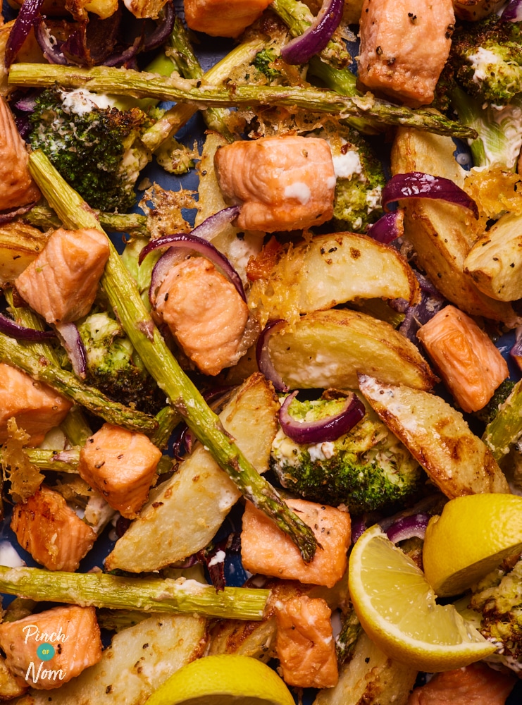 An oven tray is filled with a freshly-baked batch of Pinch of Nom's slimming-friendly Salmon, Broccoli and Potato Bake.
