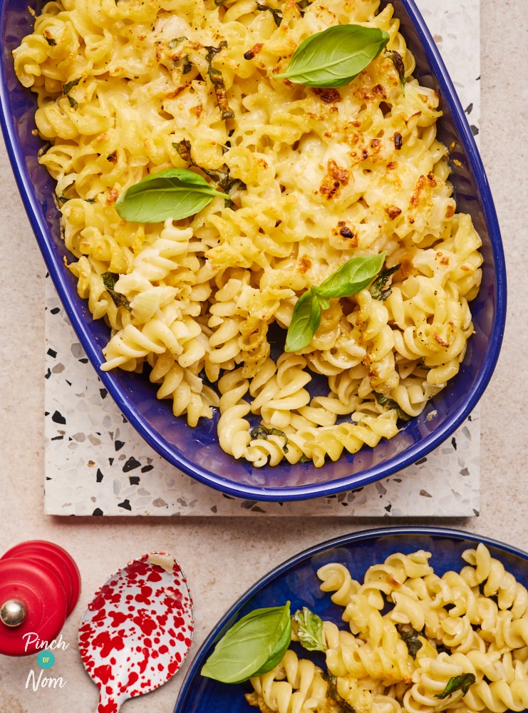 Baked cheesy pasta, topped with basil.