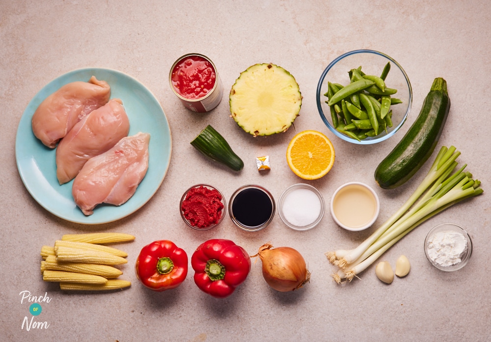 The raw ingredients for Pinch of Nom's slimming-friendly Sweet and Sour Chicken are laid out on a kitchen counter, ready to begin cooking.