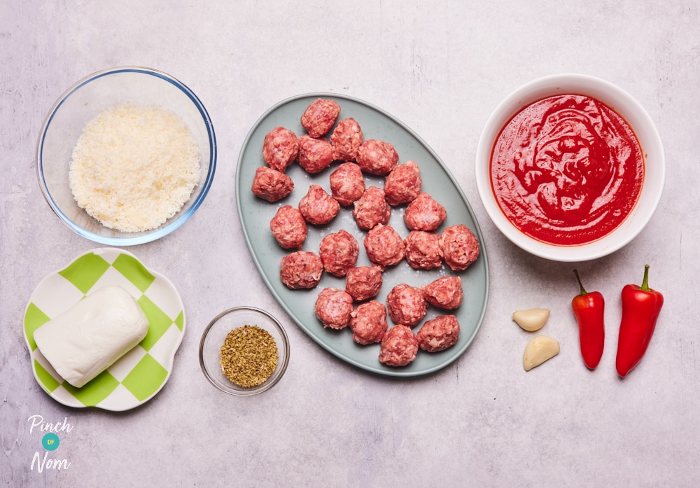 The ingredients for Pinch of Nom's Baked Spicy Meatballs are laid out on a kitchen counter, ready to begin cooking.