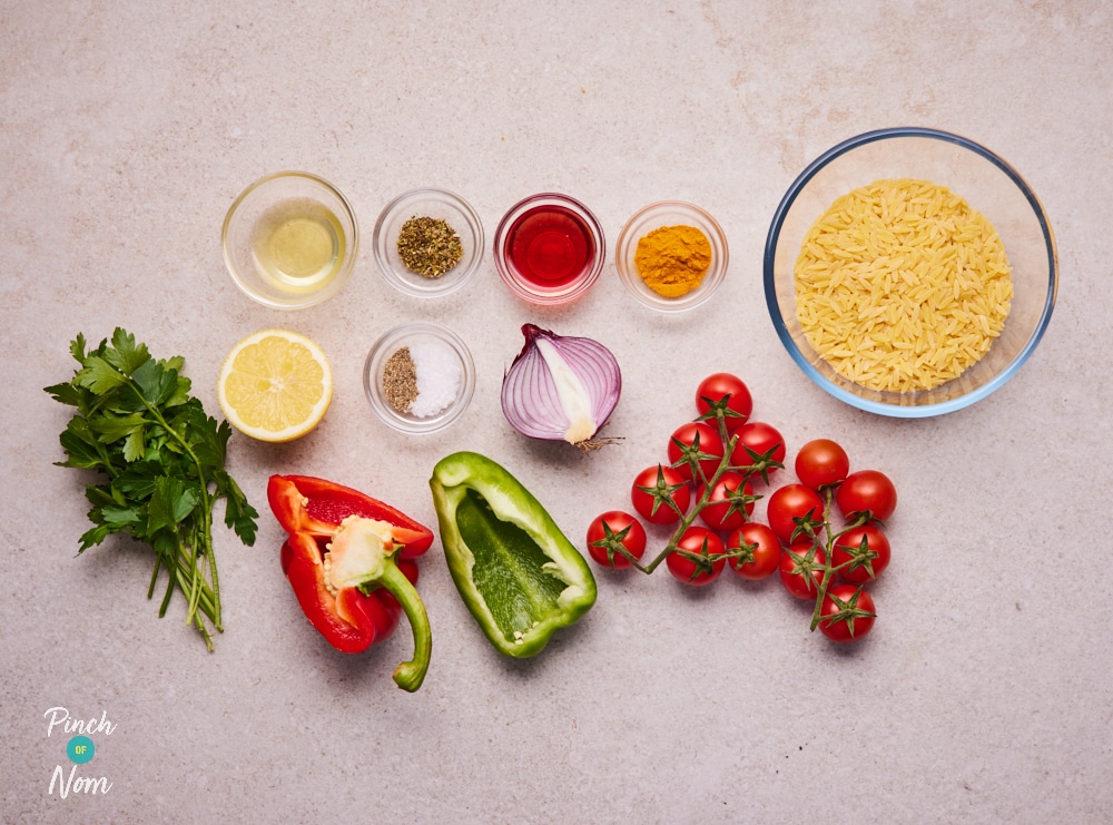 The raw ingredients for Pinch of Nom's slimming-friendly Orzo Primavera Pasta Salad are laid out on a kitchen counter, ready to begin cooking.