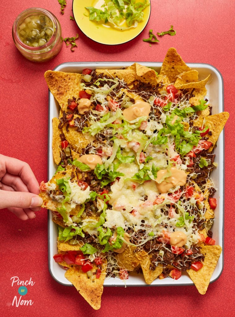 Pinch of Nom's Cheeseburger Nachos are served fresh from the oven with a topping of beef mince, lettuce, onion, gooey cheese and burger sauce.