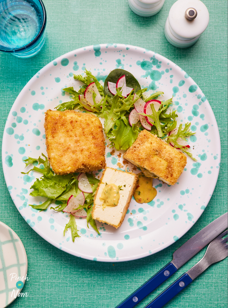 On a plate, Pinch of Nom's slimming-friendly Mini Tofu Kyivs are served on a leafy green bed of fresh salad.