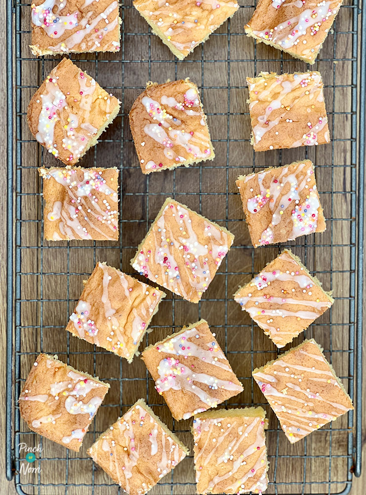 A cooling rack is filled with a fresh batch of Pinch of Nom's slimming-friendly Sprinkle Sponge squares.
