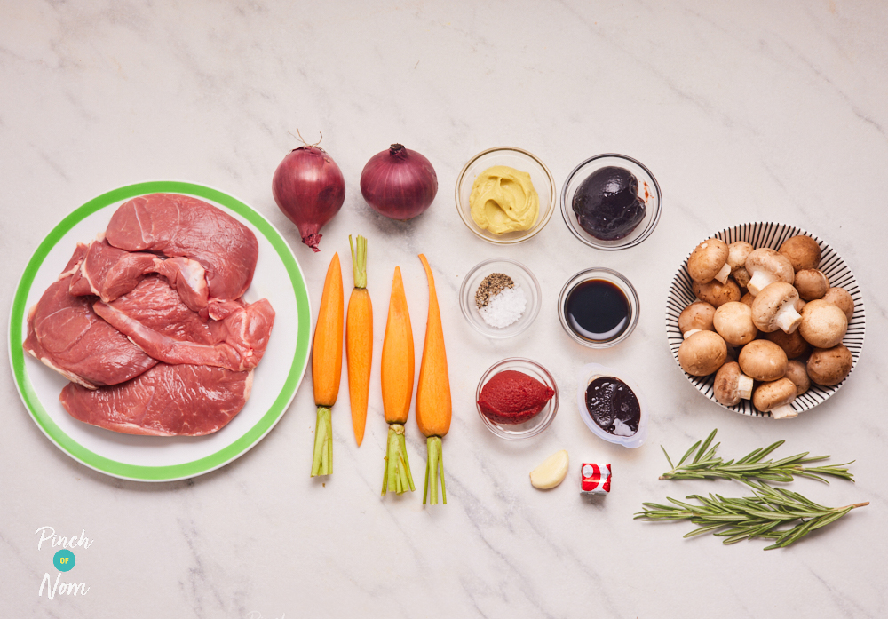 Uncooked ingredients for Pinch of Nom's Lamb Steaks with Redcurrant and Rosemary Gravy laid out on a tabletop.