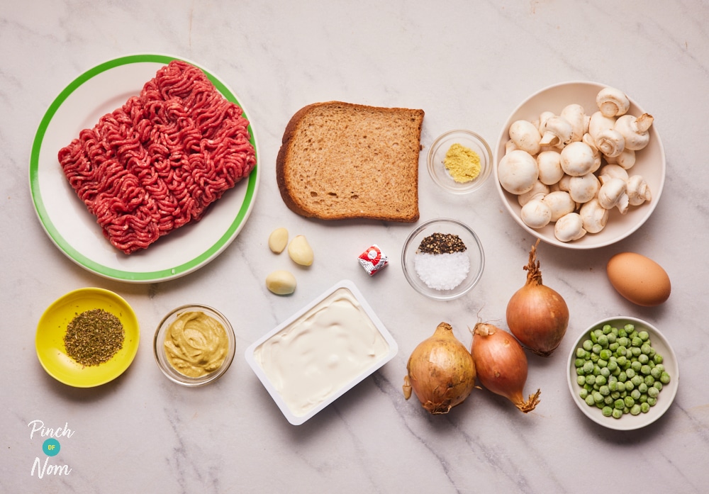 The ingredients for Pinch of Nom's Creamy Dijon Meatballs recipe are laid out on a white, marbled kitchen surface.