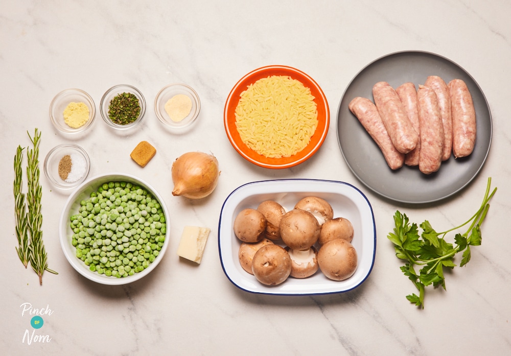 The ingredients for Pinch of Nom's Herby Sausage Orzo are laid out on a kitchen counter, ready to begin cooking.