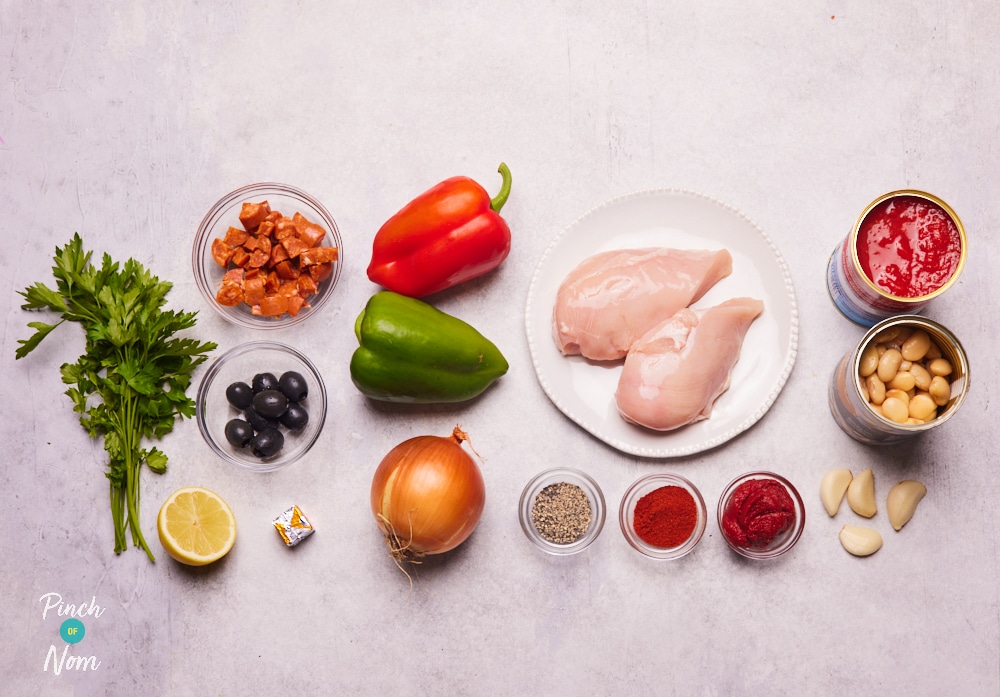 The ingredients for Pinch of Nom's Spanish-Style Pulled Chicken are laid out on a kitchen counter, ready to begin cooking.