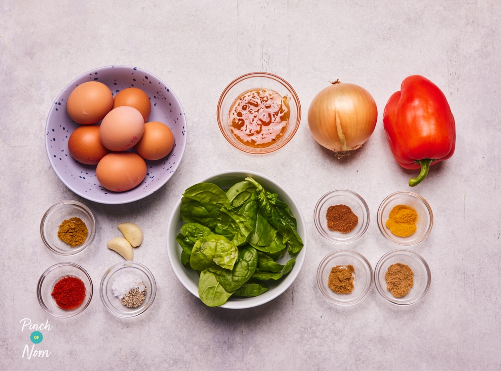 The raw ingredients for Pinch of Nom's slimming-friendly Tikka-Style Frittata are laid out on a kitchen counter, ready to begin cooking.