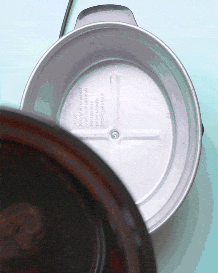 A sparkling clean slow cooker inner pot is placed inside the slow cooker exterior after cleaning.