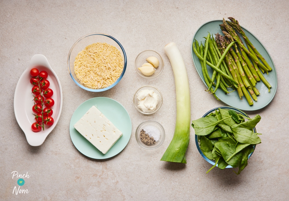 The raw ingredients for Pinch of Nom's slimming-friendly Baked Feta Orzo are laid out on a kitchen counter, ready to begin cooking.