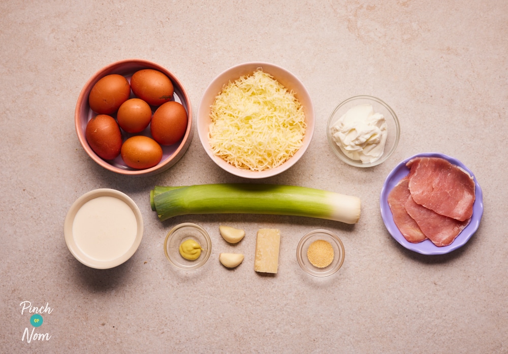The raw ingredients for Pinch of Nom's slimming-friendly Carbonata Quiche are laid out on a kitchen counter, ready to begin cooking.