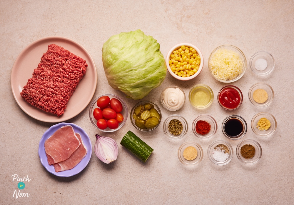 The raw ingredients for Pinch of Nom's slimming-friendly Cheeseburger Chopped Salad are laid out on a kitchen counter, ready to begin cooking.