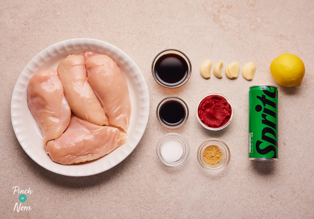 The raw ingredients for Pinch of Nom's slimming-friendly Lemonade Chicken Skewers are laid out on a kitchen counter, ready to begin cooking.