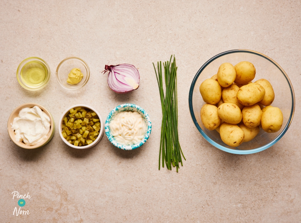 The raw ingredients for Pinch of Nom's slimming-friendly Pickle Potato Salad are laid out on a kitchen counter, ready to begin cooking.