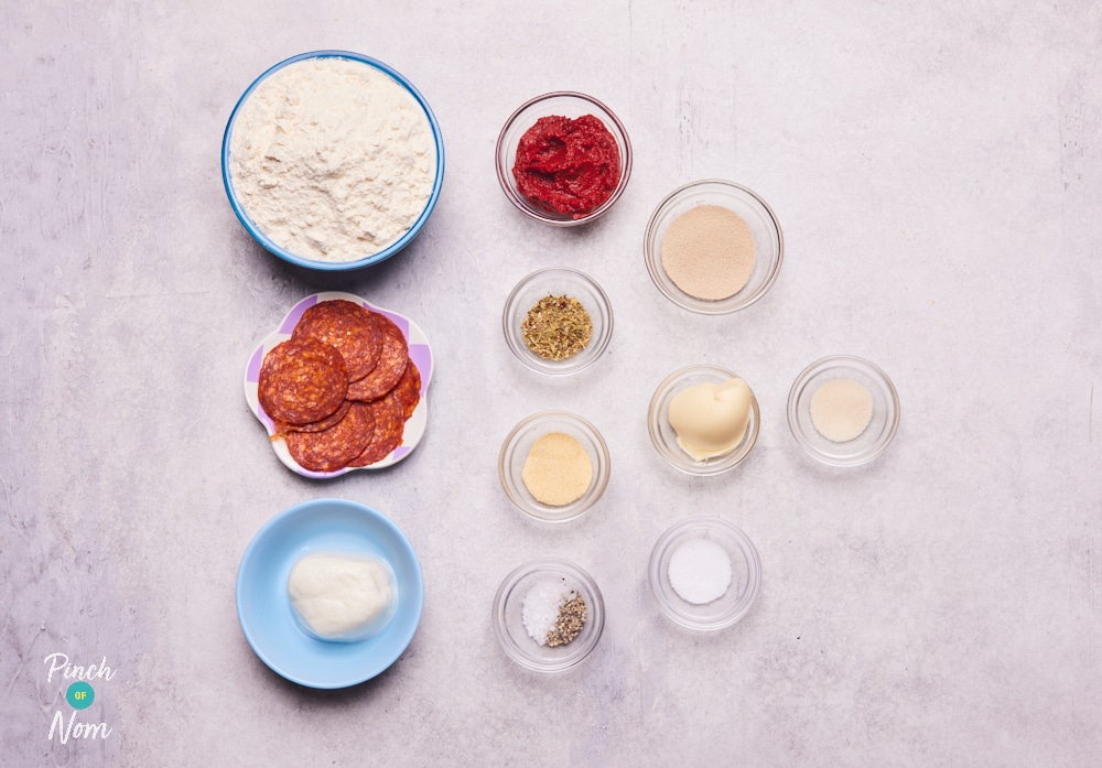 The raw ingredients for Pinch of Nom's slimming-friendly Pizza Dough Balls are laid out on a kitchen counter, ready to begin cooking.