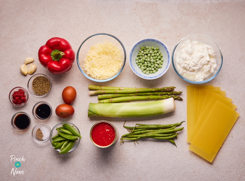 The raw ingredients for Pinch of Nom's slimming-friendly Summer Vegetable Lasagne are laid out on a kitchen counter, ready to begin cooking.