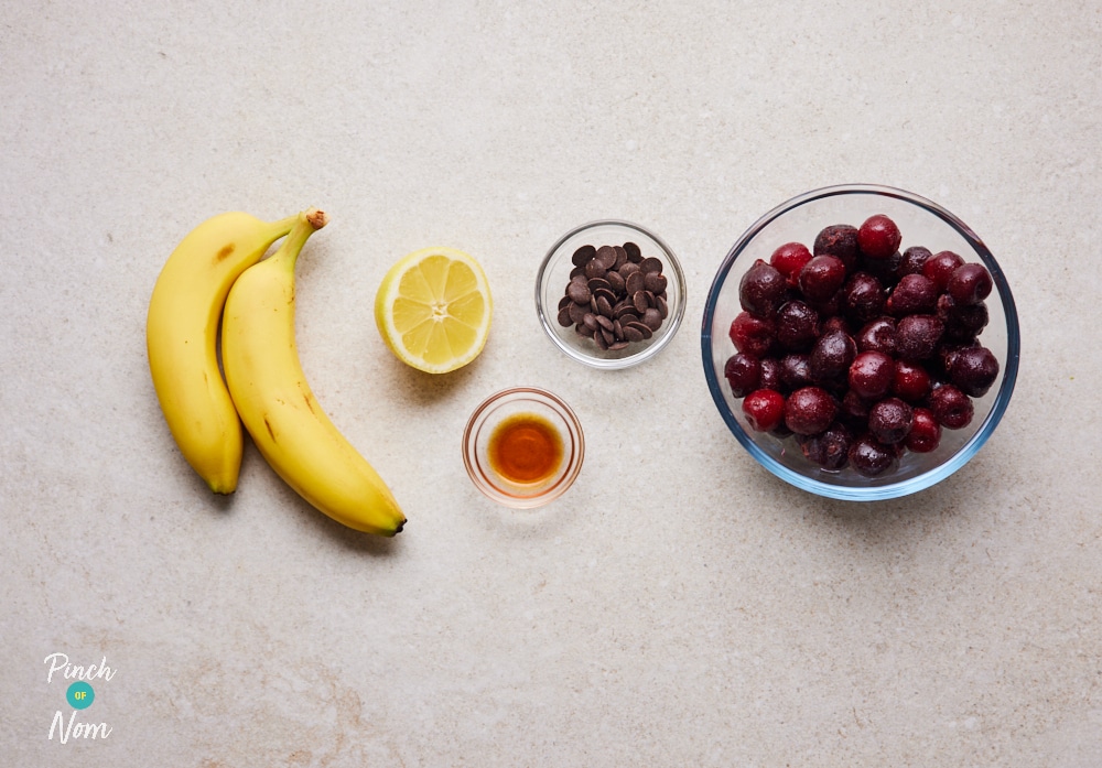 The raw ingredients for Pinch of Nom's slimming-friendly Cherry Choc Chip Ice Cream are laid out on a kitchen counter, ready to begin making.