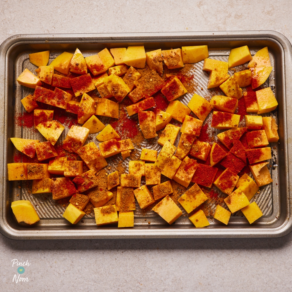 Pumpkin topped with Cajun spiced and placed on baking tray.
